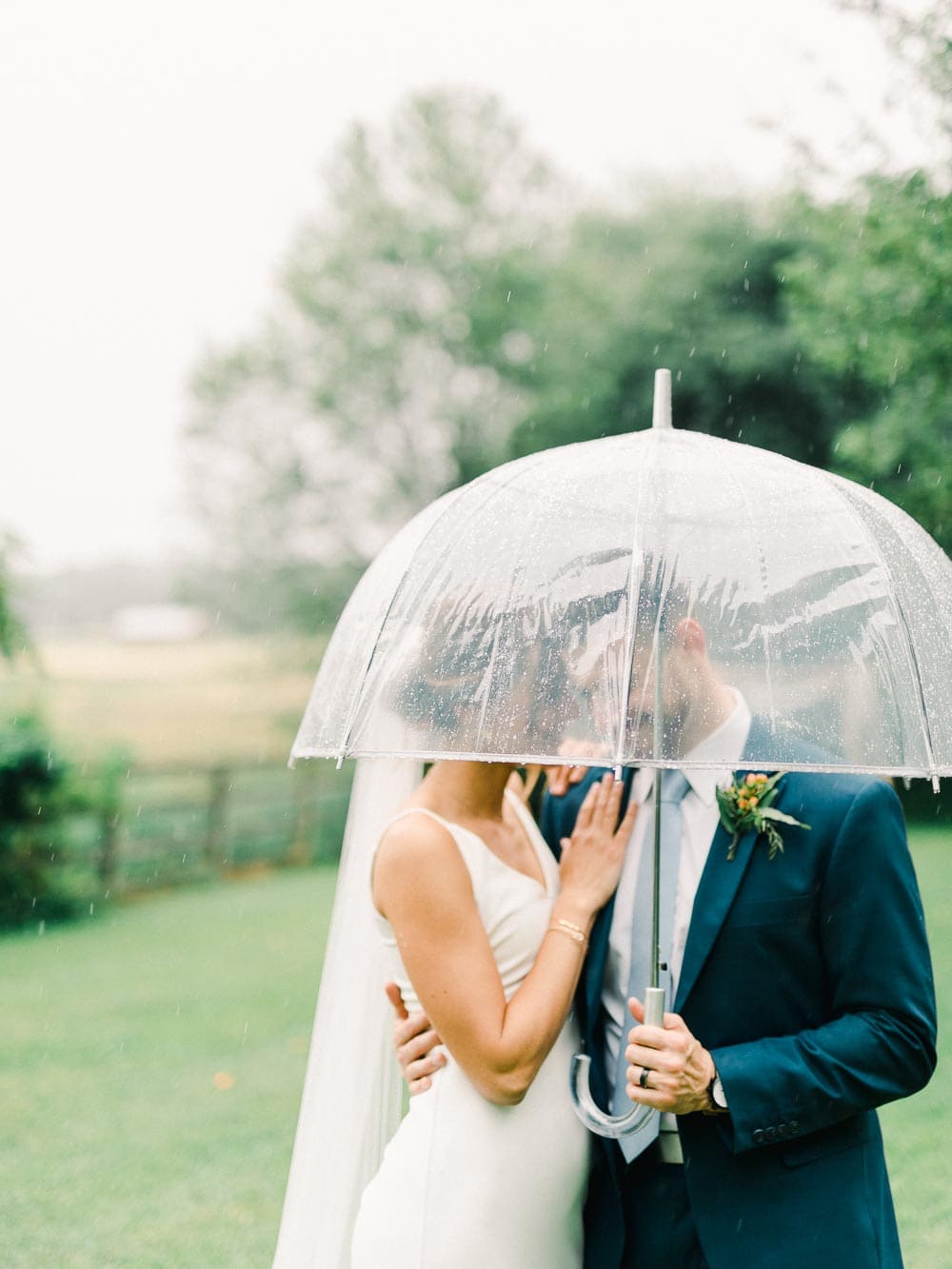 rainy day portraits during couple's intimate backyard wedding in cleveland Ohio