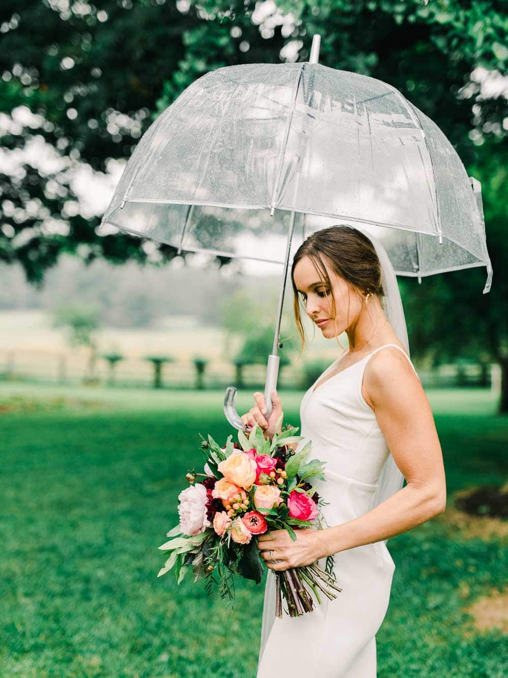 bride holding umbrella during her intimate backyard wedding in cleveland Ohio