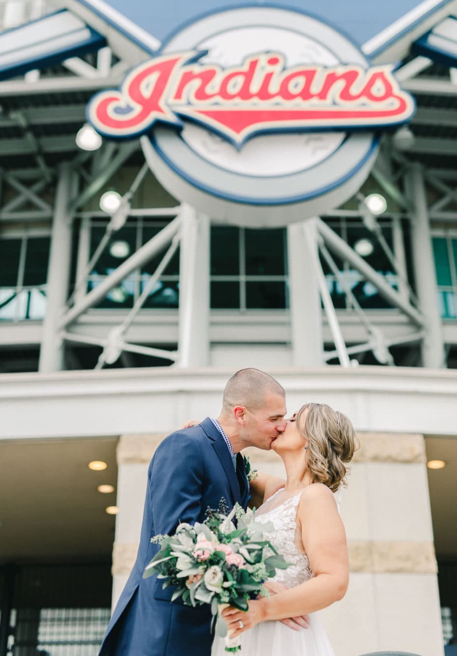 bride and groom kissing in front of progressive field in Cleveland Ohio
