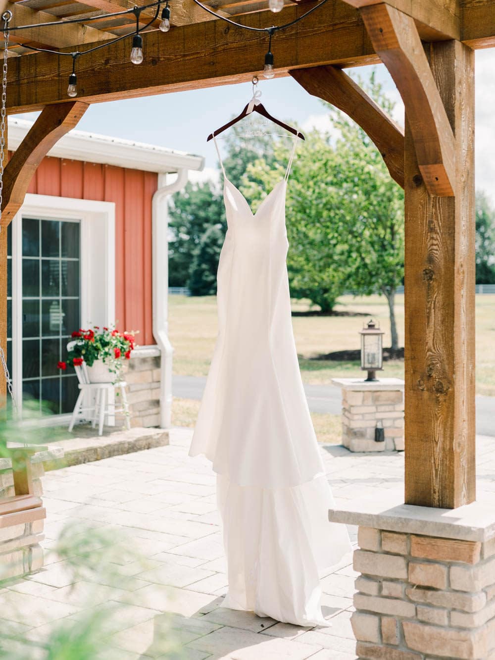 wedding dress on a hanger before bride gets dressed at Nolan barn 