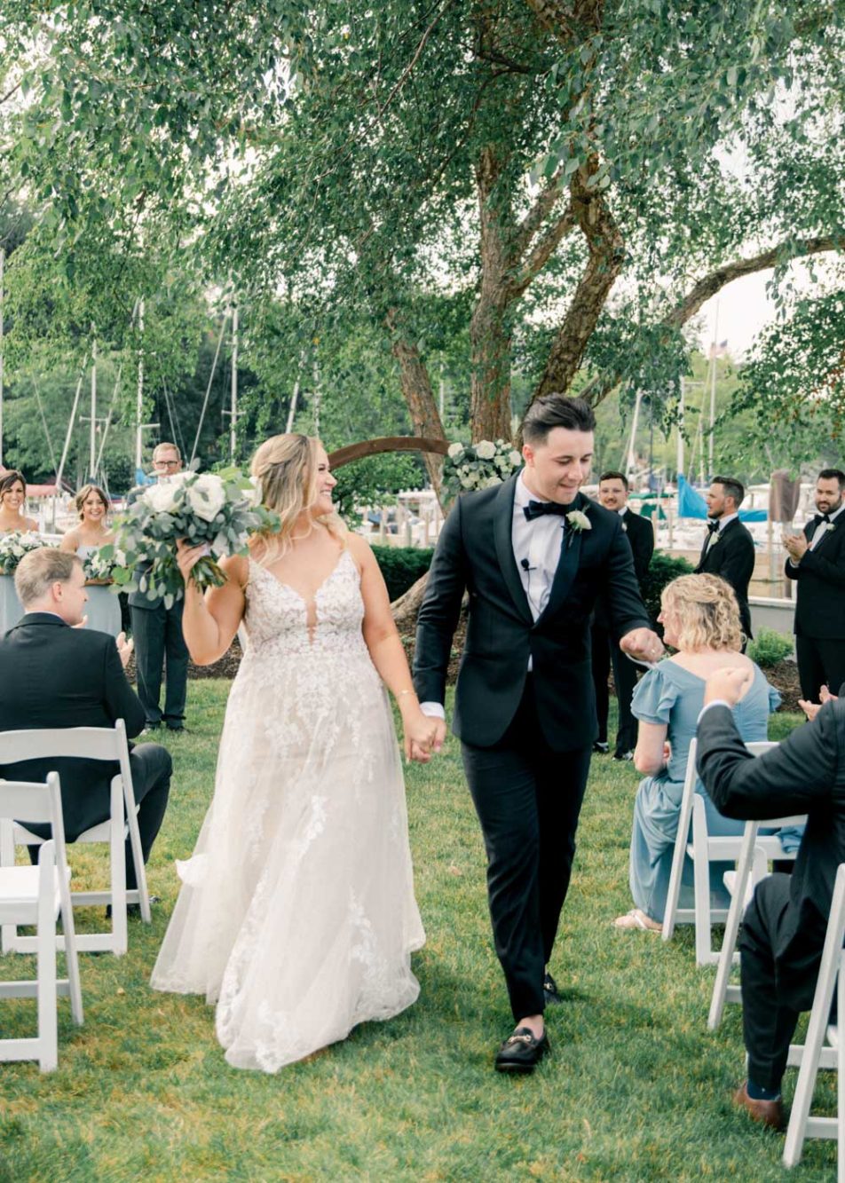 Cleveland Yacht Club wedding recessional, couple excited after being married