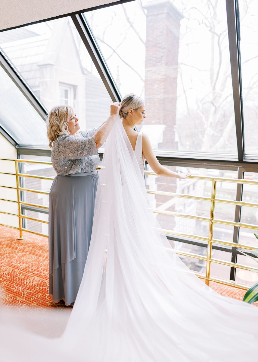 mom helping bride put veil in at her wedding at Glidden House 