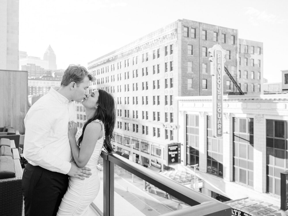 Couple kissing on the rooftop at Cleveland downtown for engagement photos