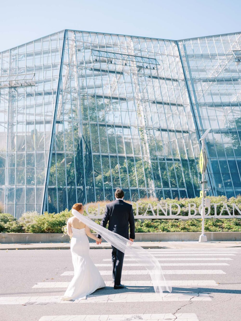 Bride and groom crossing the street near Cleveland Botanical Garden