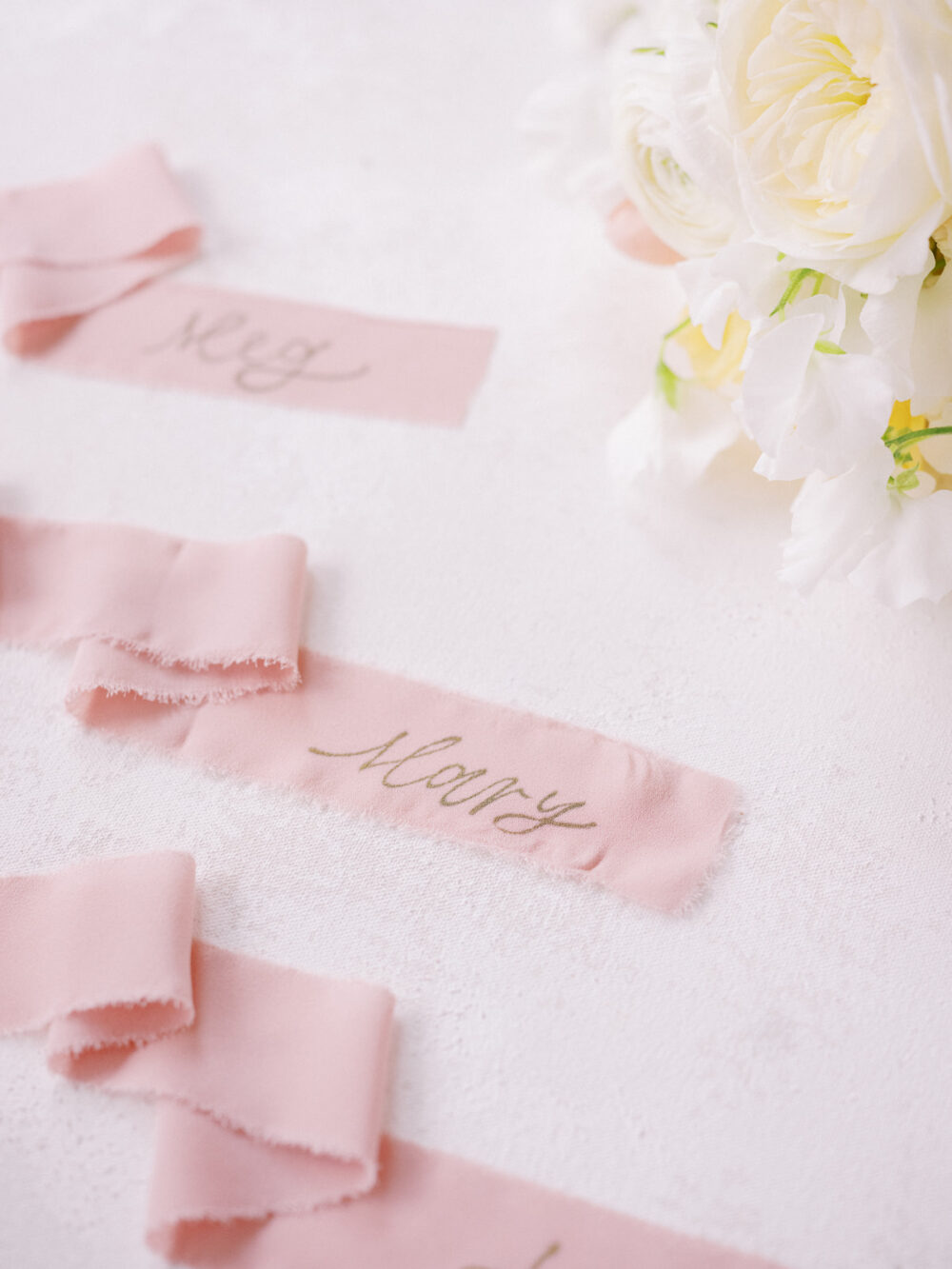 Calligraphy on a ribbon for wedding champagne