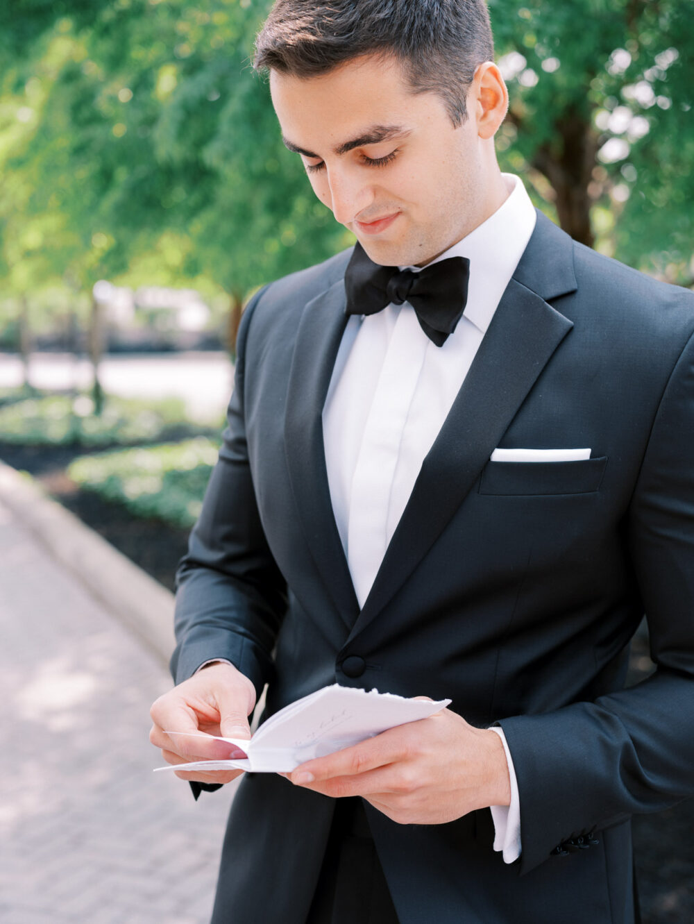 Groom reading a letter from the bride at Crocker Park