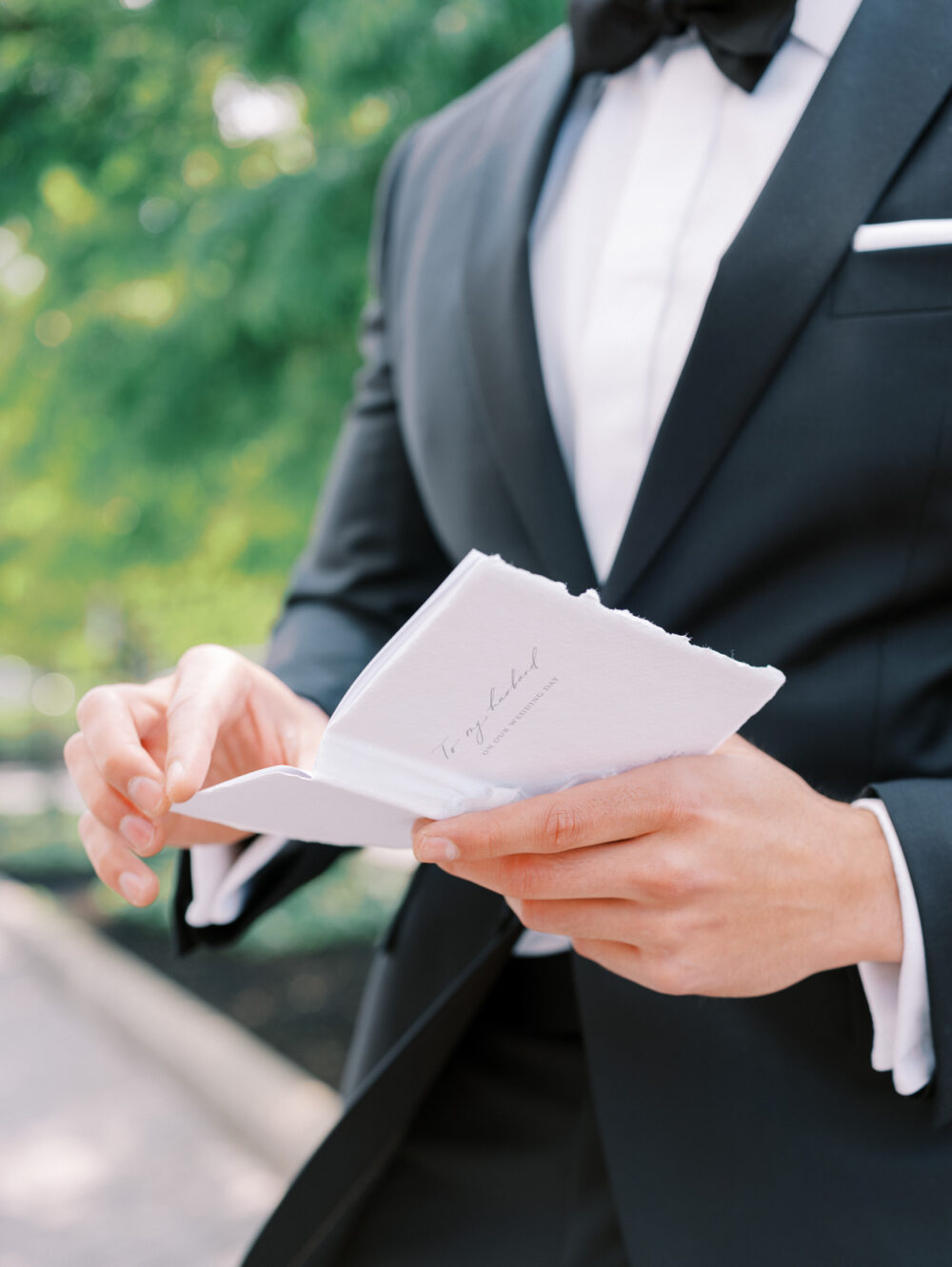 Groom reading a letter from the bride at Crocker Park