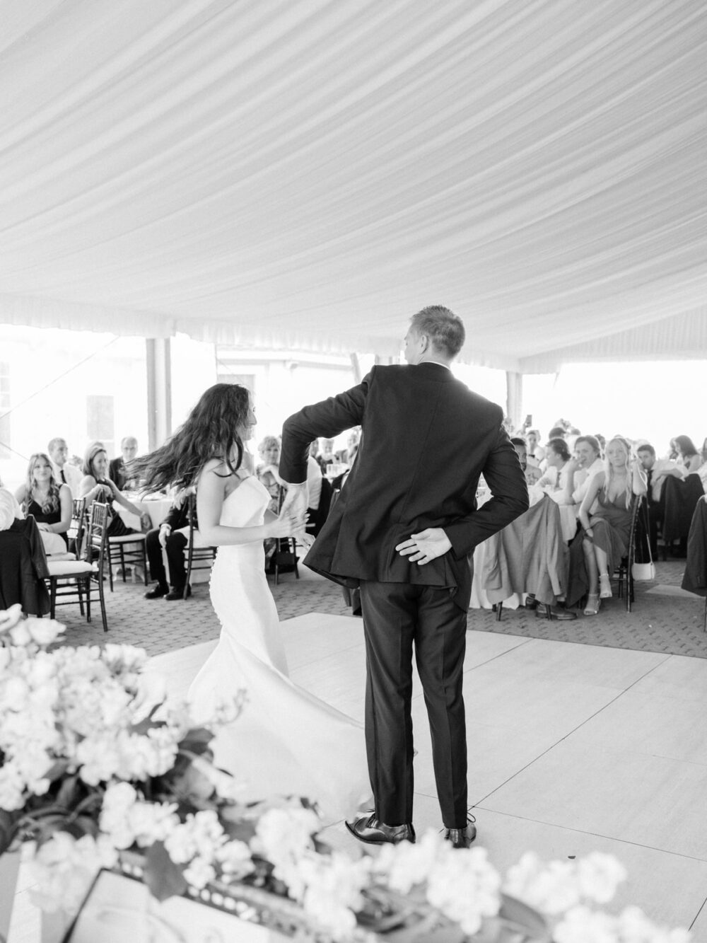 Bride and groom first dance at a tented reception at Shoreby Club for a summer wedding