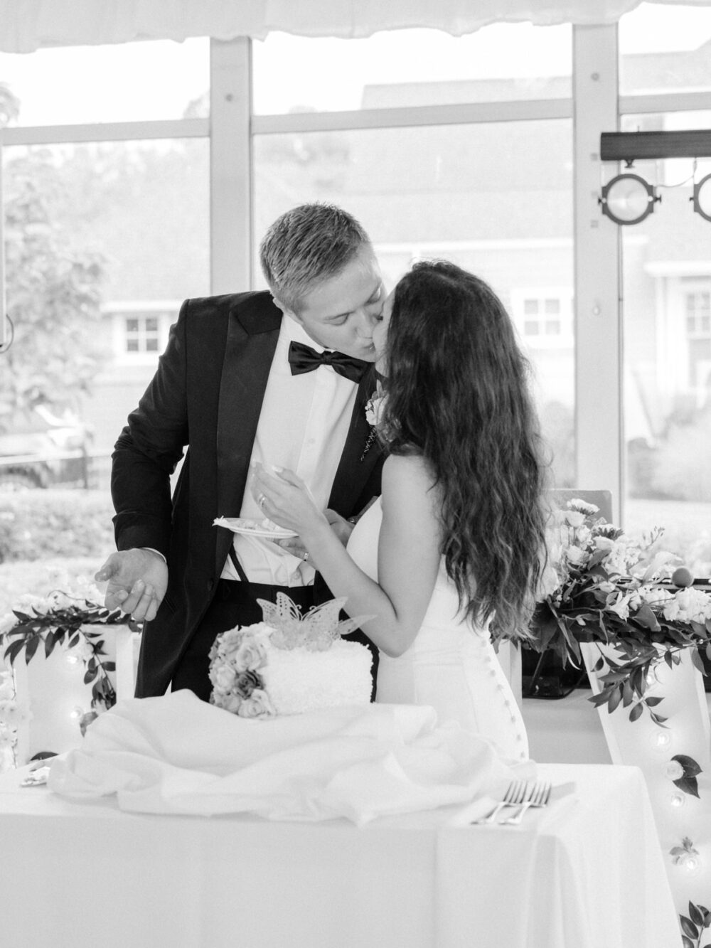Bride and groom sharing a kiss during their Shoreby Club tented reception