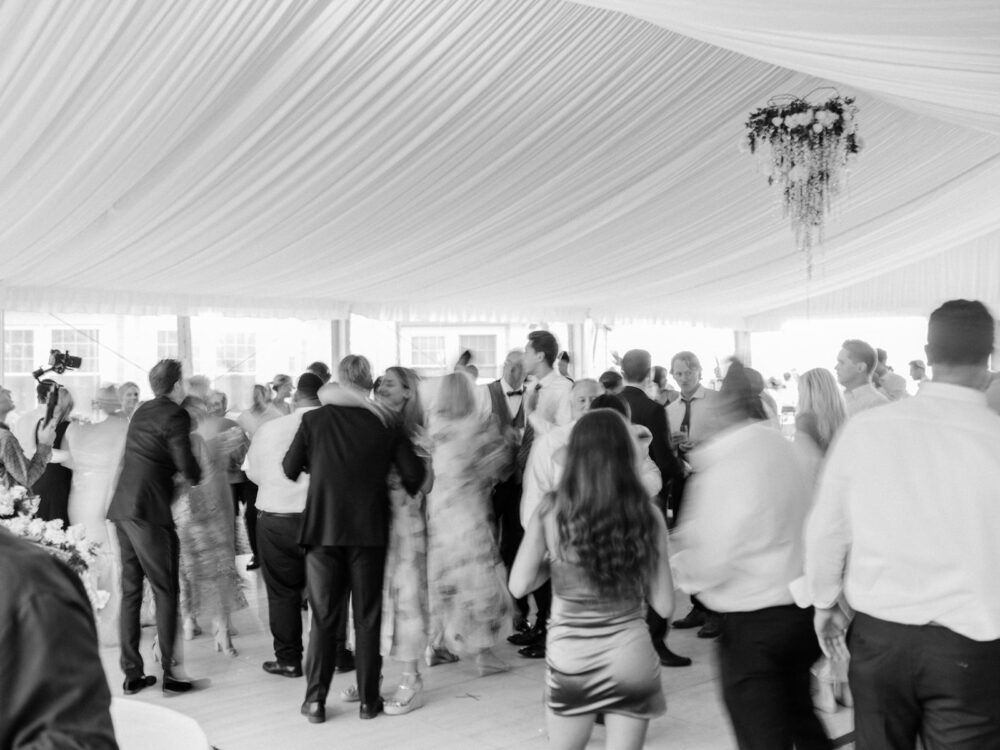 Guests dancing at a tented reception at Shoreby Club for a summer wedding