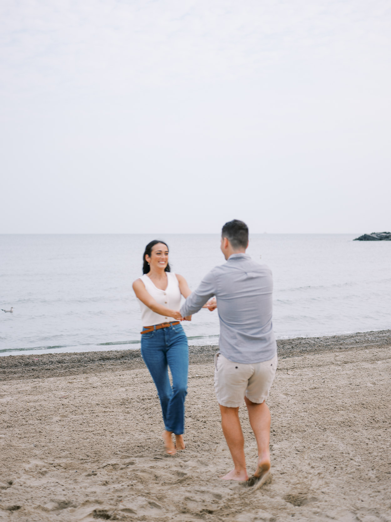 Couple spinning at their sunrise Edgewater Beach engagement in Cleveland, Ohio