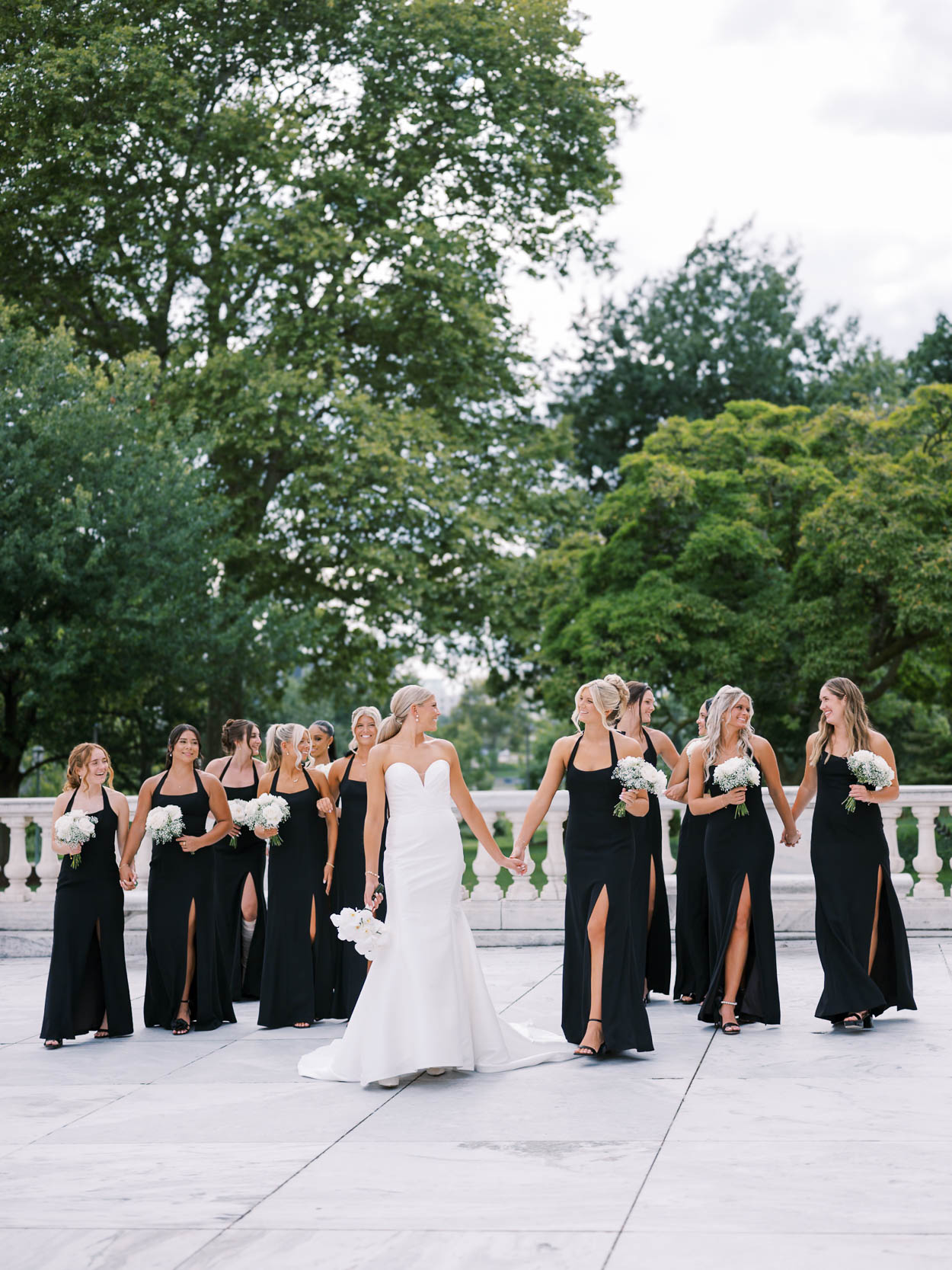 bridesmaids walking with bride at the Cleveland Art Museum before their Windows on the River wedding