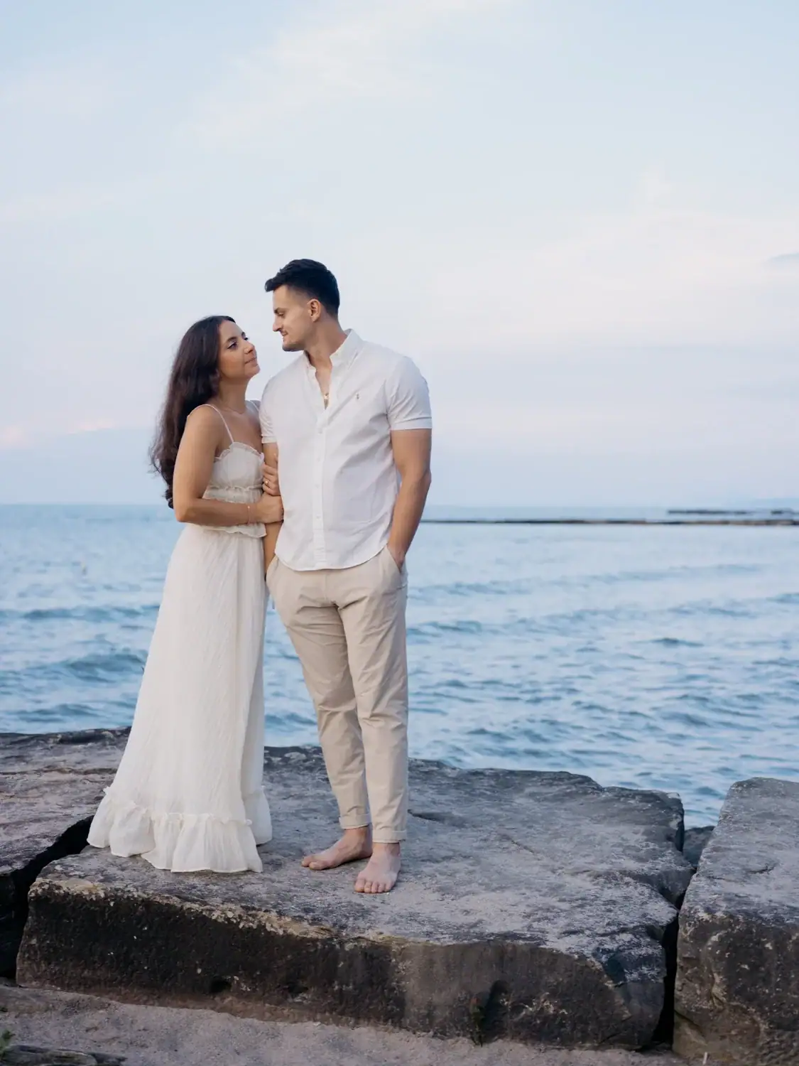 Couple embracing each other at their Cleveland beach engagement