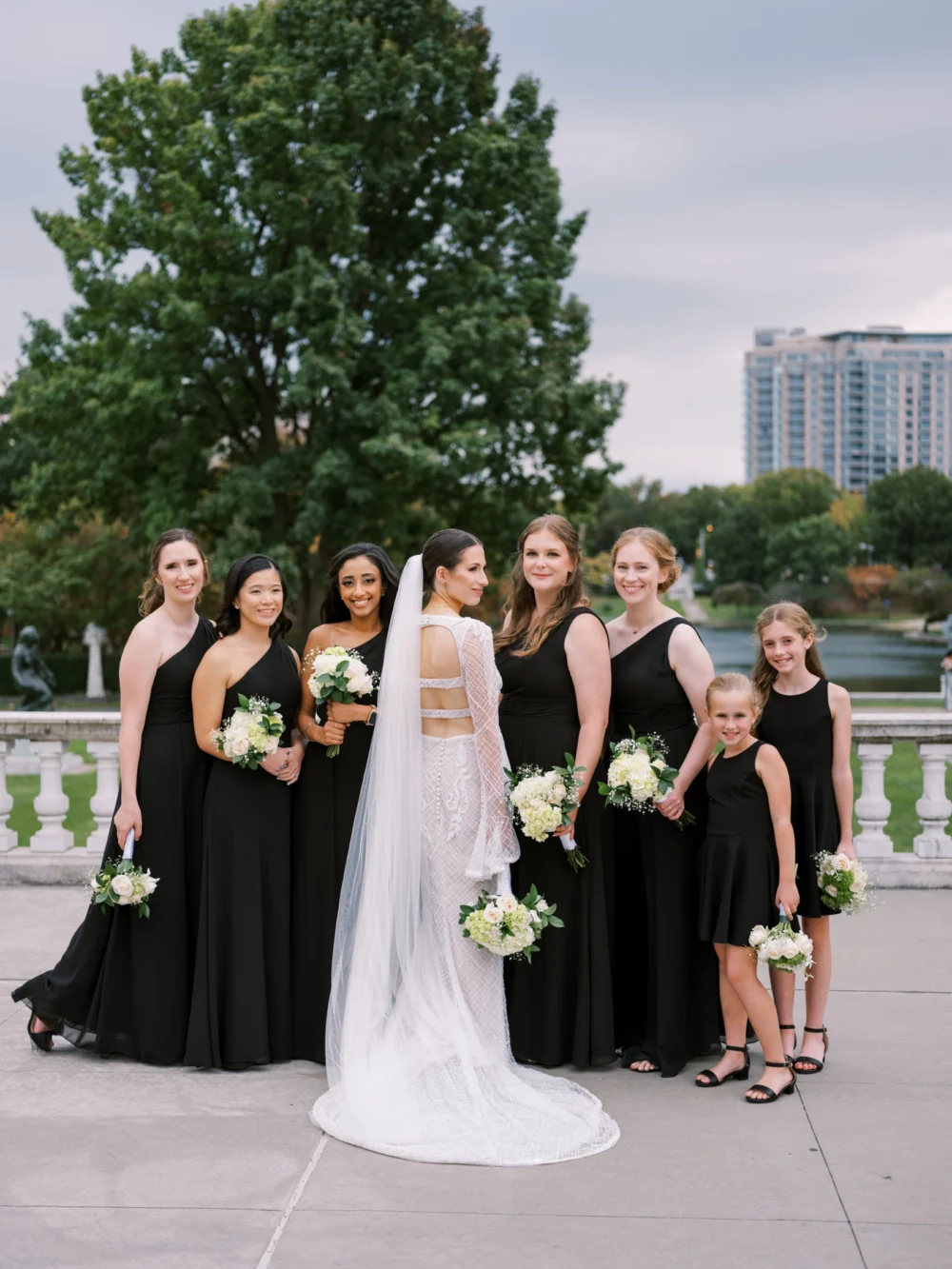Bride with her bridesmaids at Cleveland Art museum, bride wearing J. Andreatta wedding dress