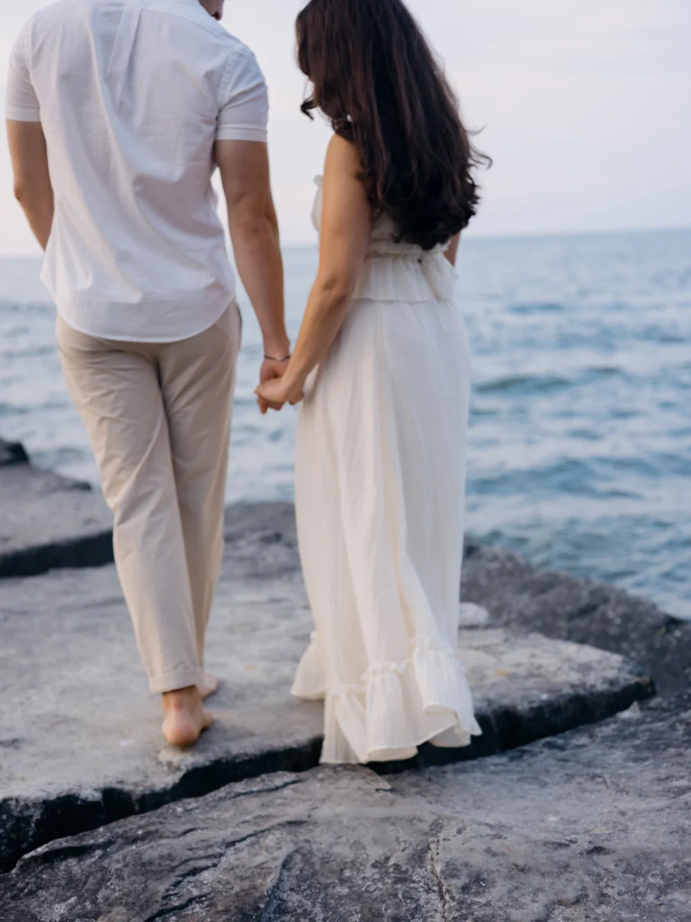 Couple walking during their waterfront Charleston engagement session