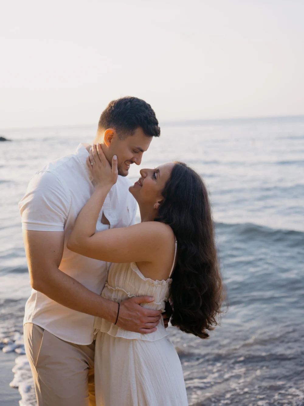 Bride and groom gazing into each other's eyes during their Charleston beach engagement session