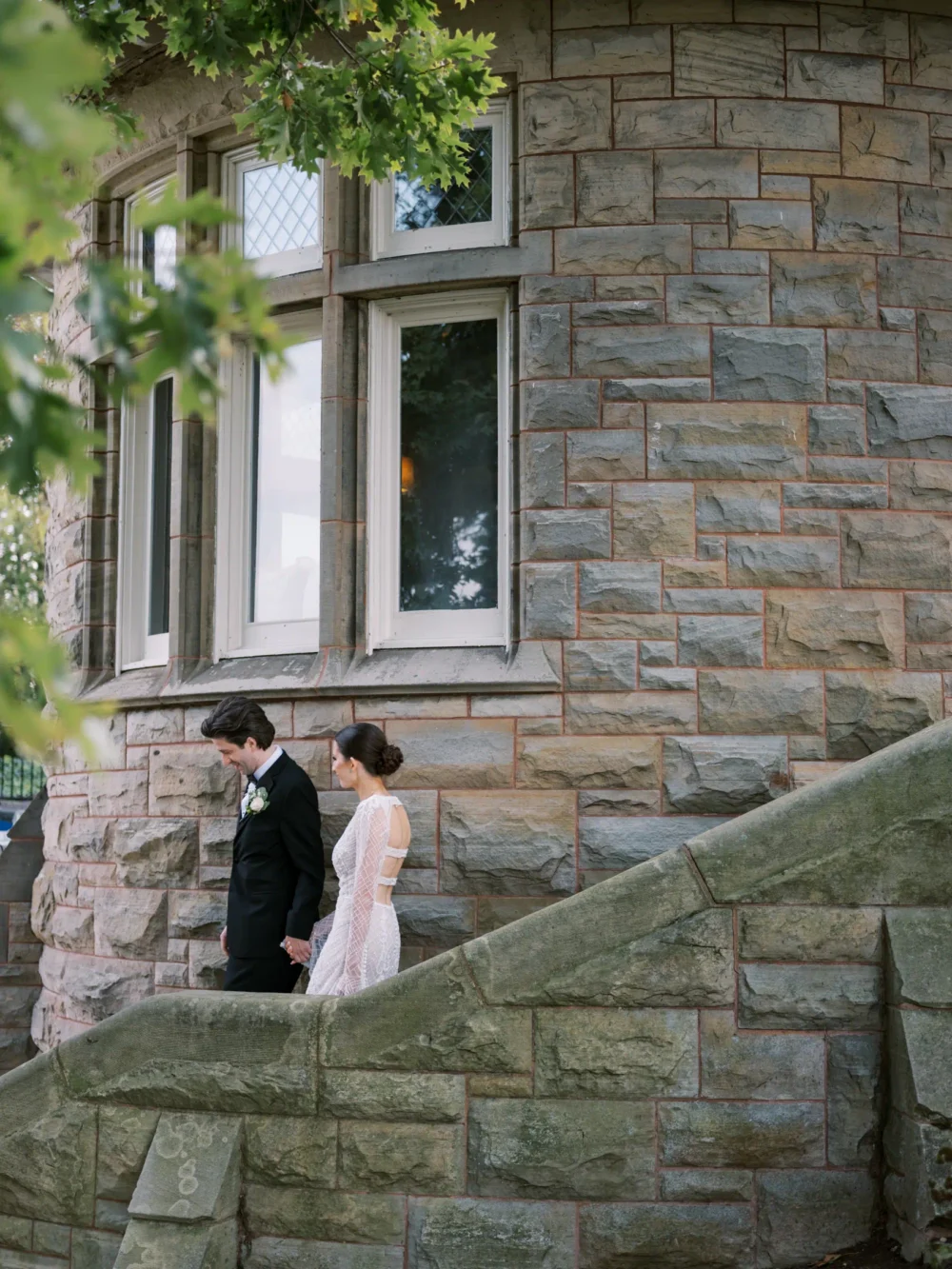 Bride and groom walking down steps at Shoreby Club during their dream Cleveland wedding