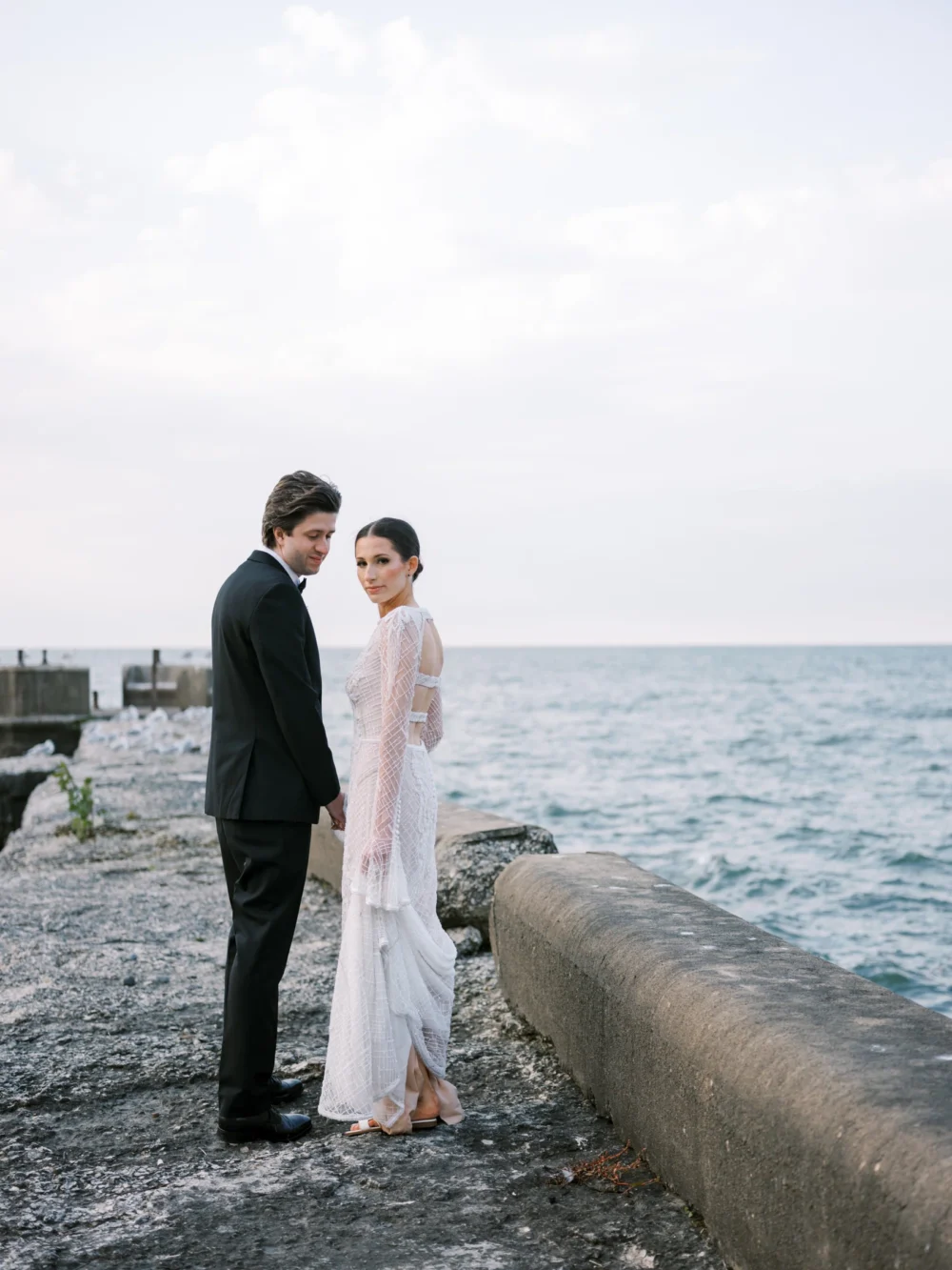 Bride and groom on the pier at Shoreby Club during their dream Cleveland wedding
