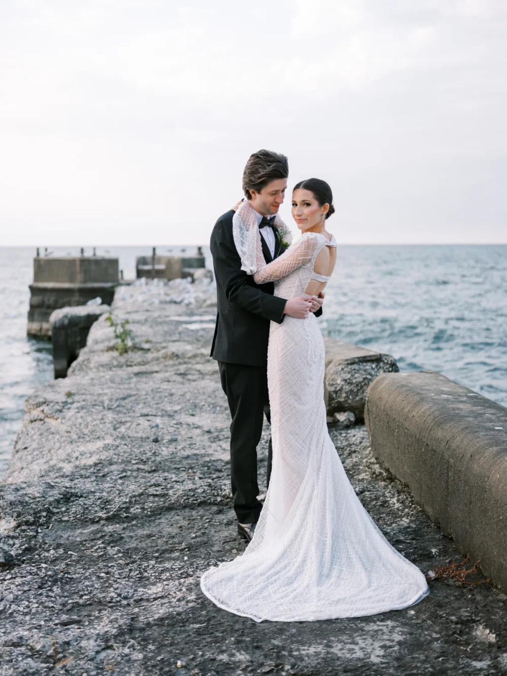 Bride and groom on the pier at Shoreby Club during their dream Cleveland wedding