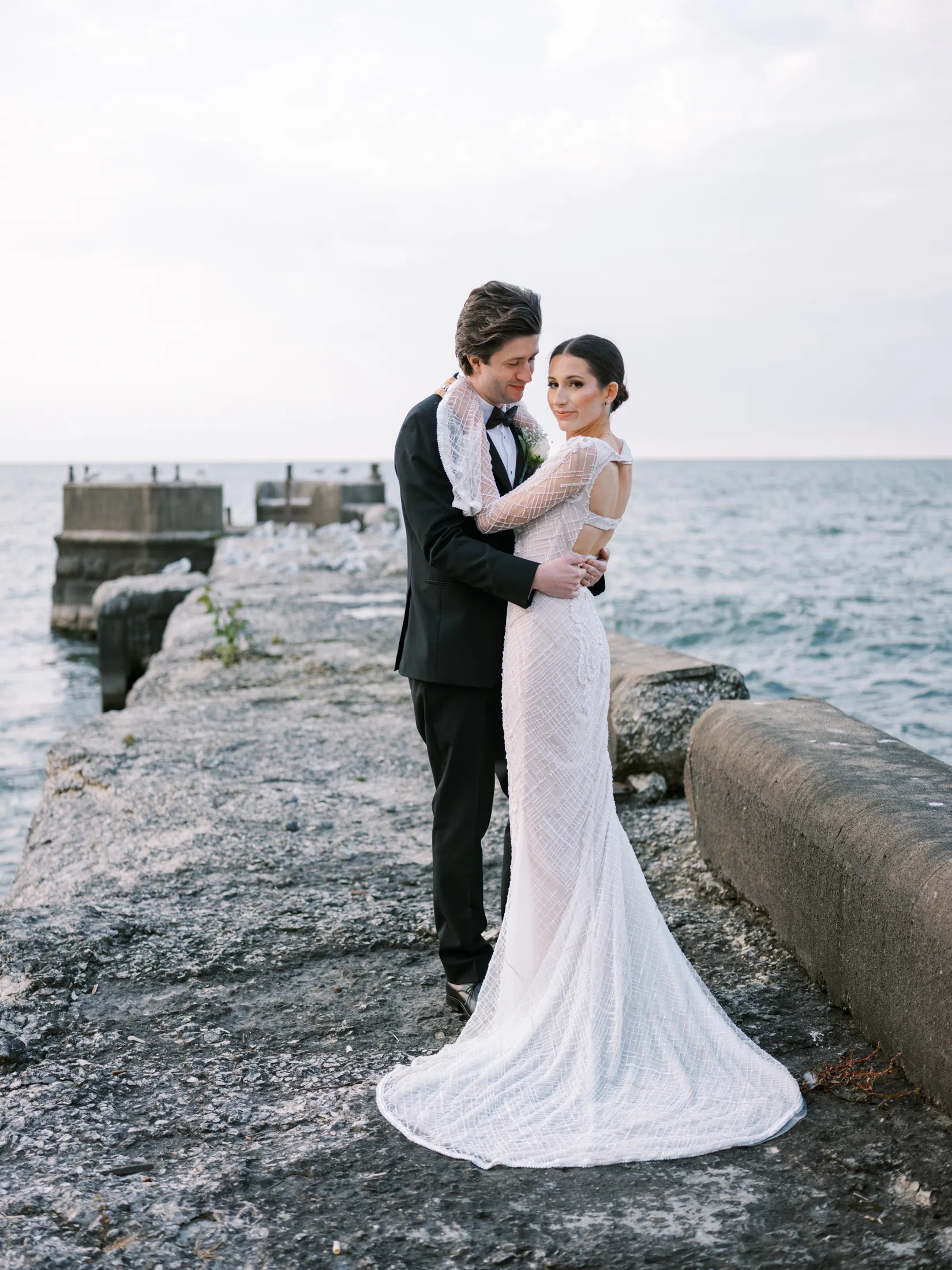 Bride and groom on the pier at Shoreby Club during their dream Cleveland wedding
