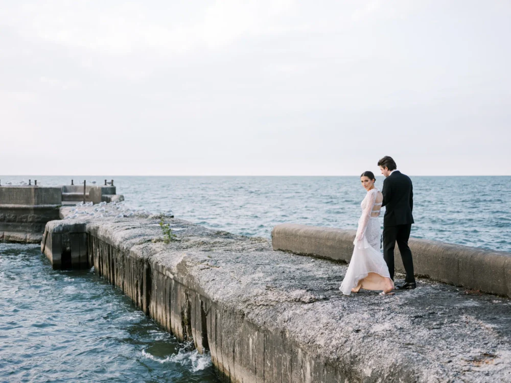 Bride and groom on the pier at Shoreby Club during their dream Cleveland wedding