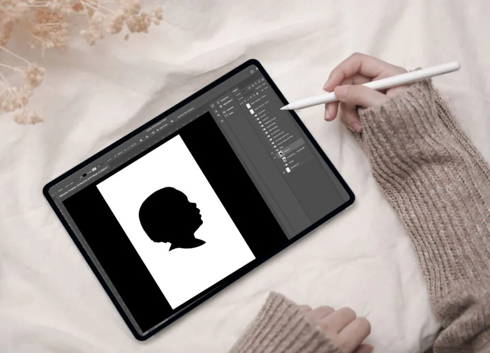 Person creating a custom silhouette on an ipad.