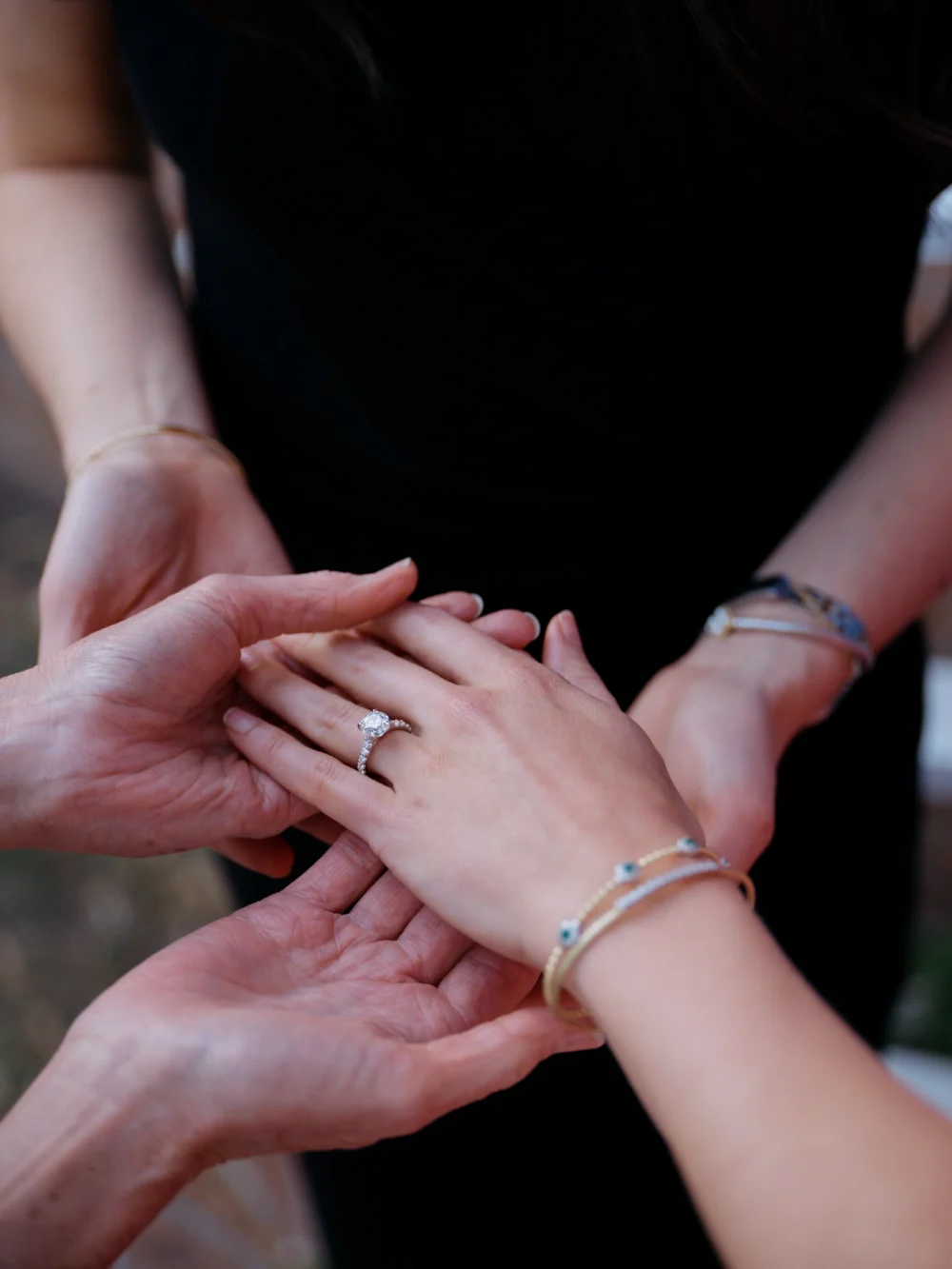 mom and sister admiring bride's ring after proposal Charleston SC