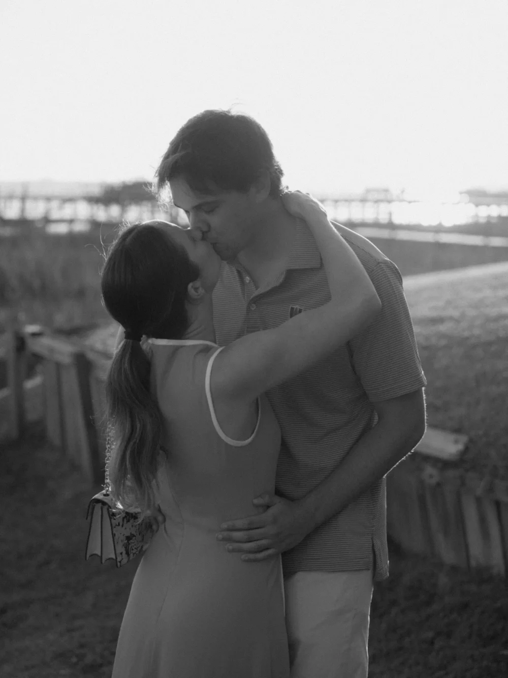 couple kissing after proposal in Charleston