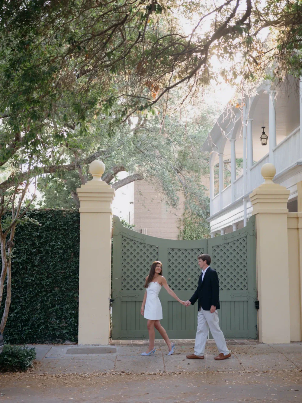 Couple walking through historic downtown Charleston during spring engagement session