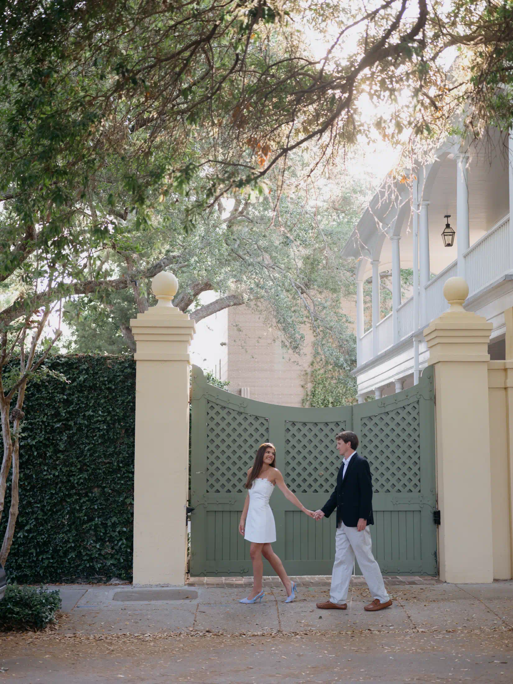 Couple walking through historic downtown Charleston during spring engagement session