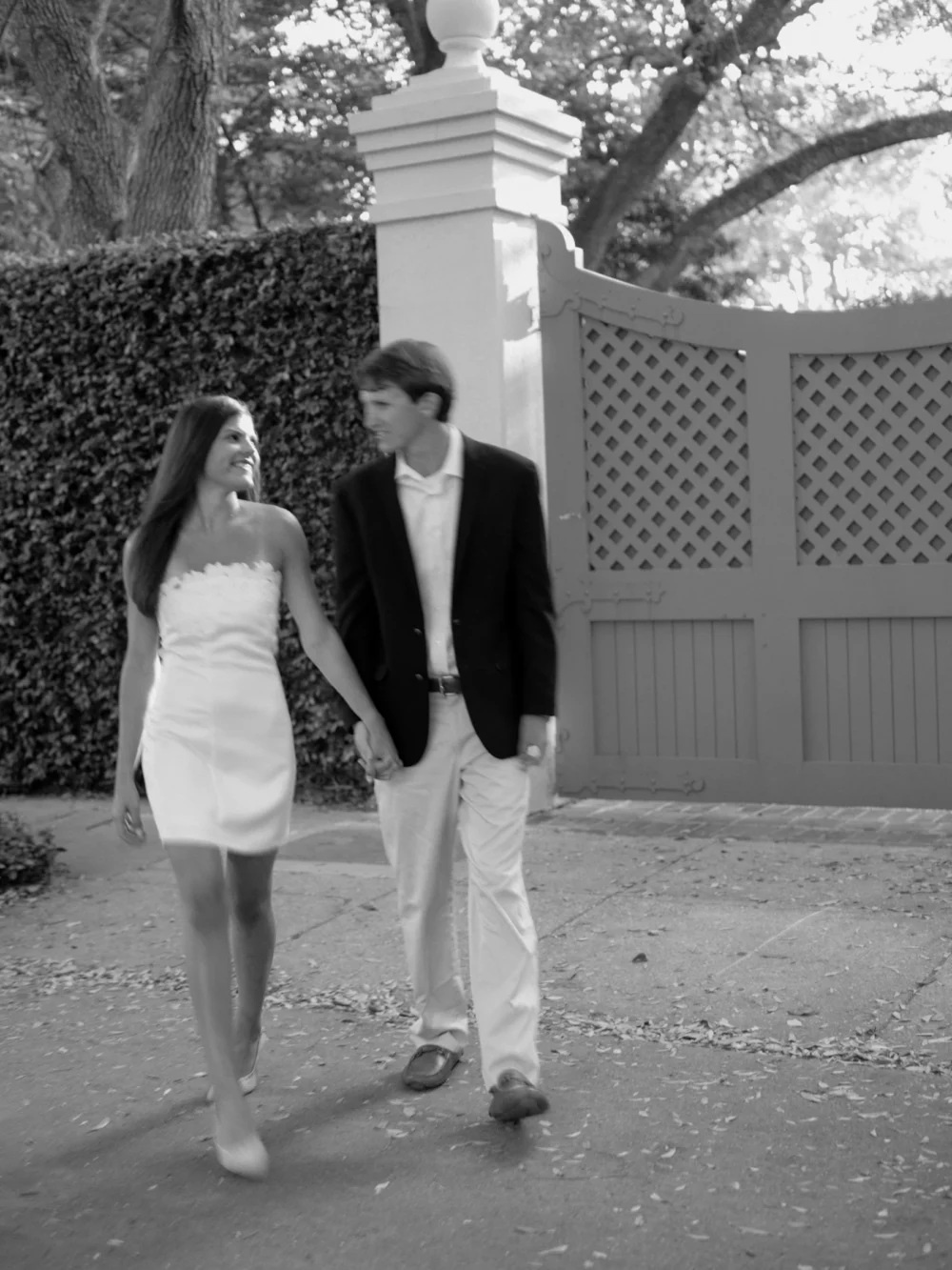Couple walking through historic downtown Charleston during spring engagement session