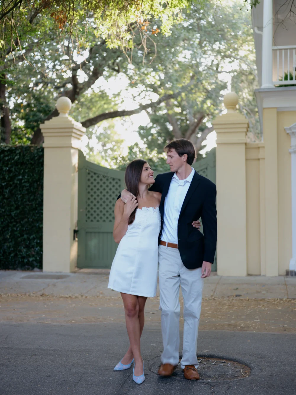 Couple walking through historic downtown Charleston during spring engagement session