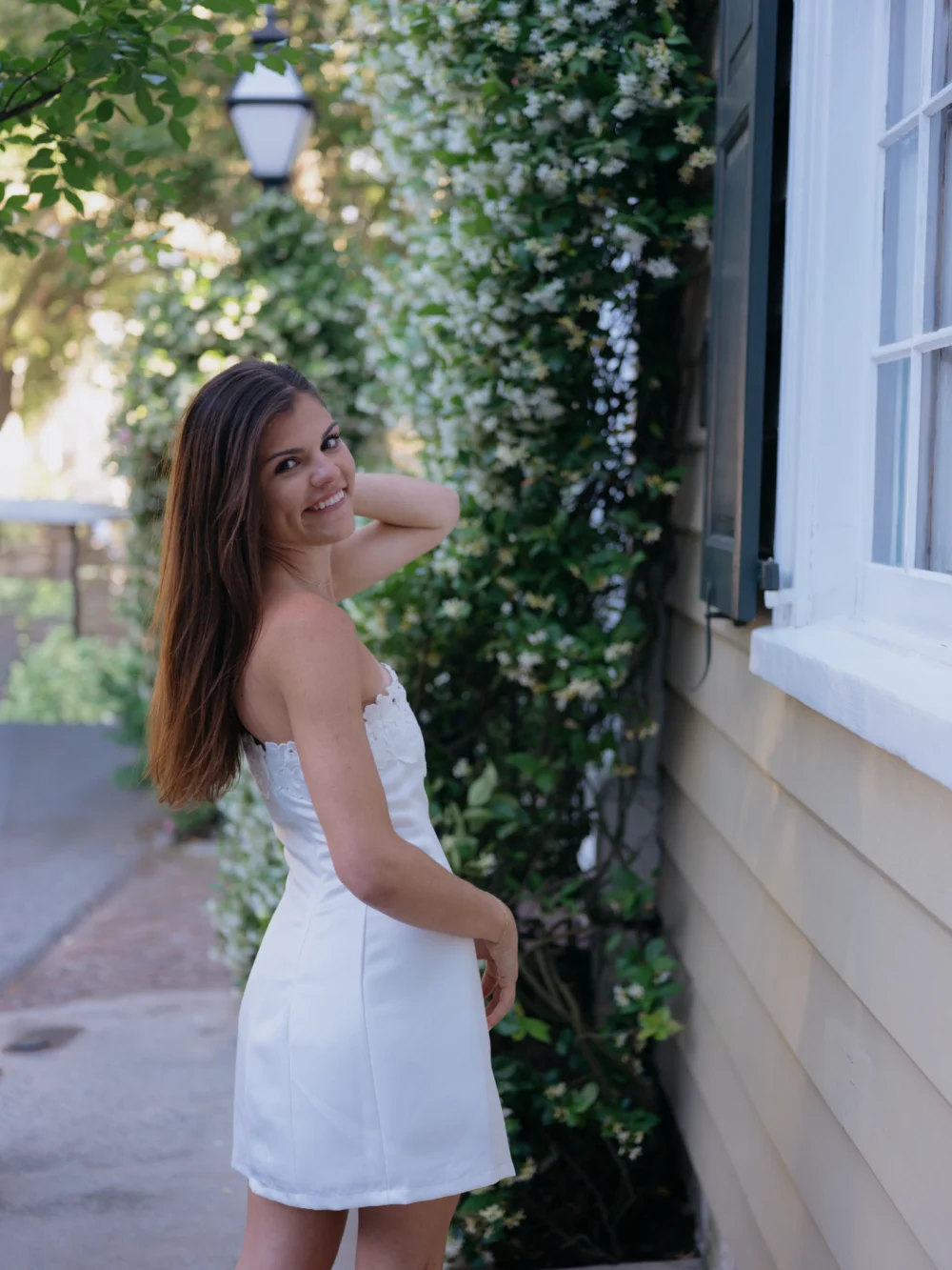 Bride-to-be in white babydoll dress during Charleston engagement session