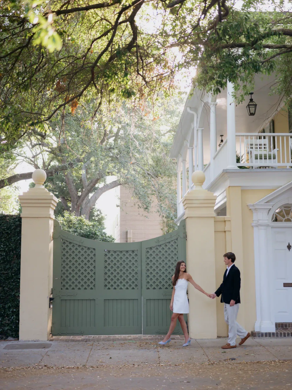 Couple walking through historic downtown Charleston during spring engagement session