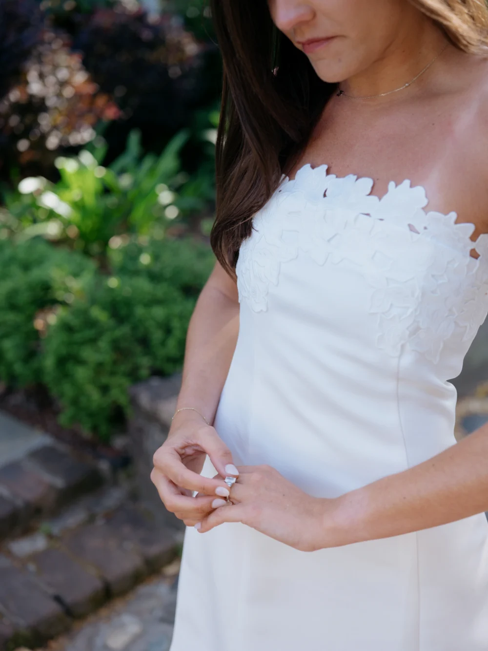 Bride-to-be in white babydoll dress during Charleston engagement session