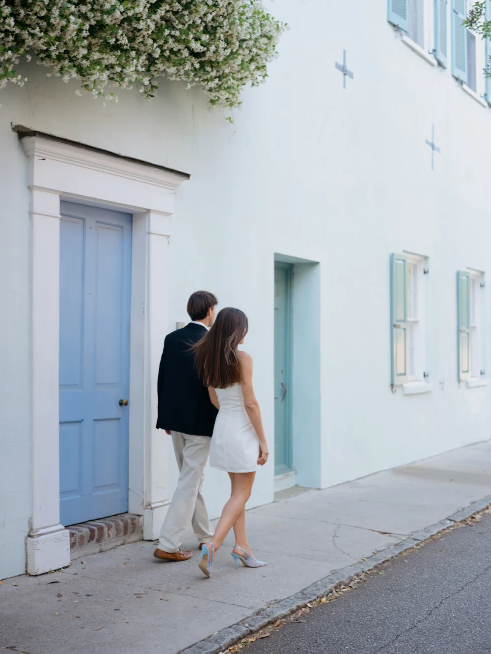 Couple walking through historic downtown Charleston during spring engagement session