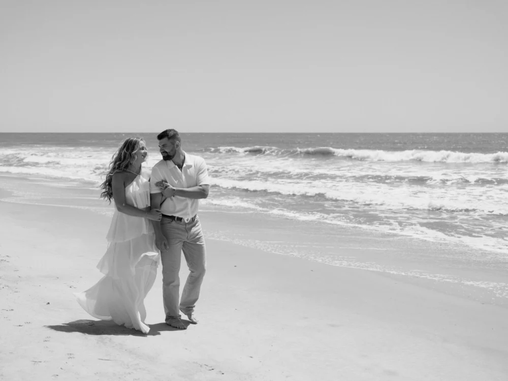 Couple walking along shoreline at Isle of Palms