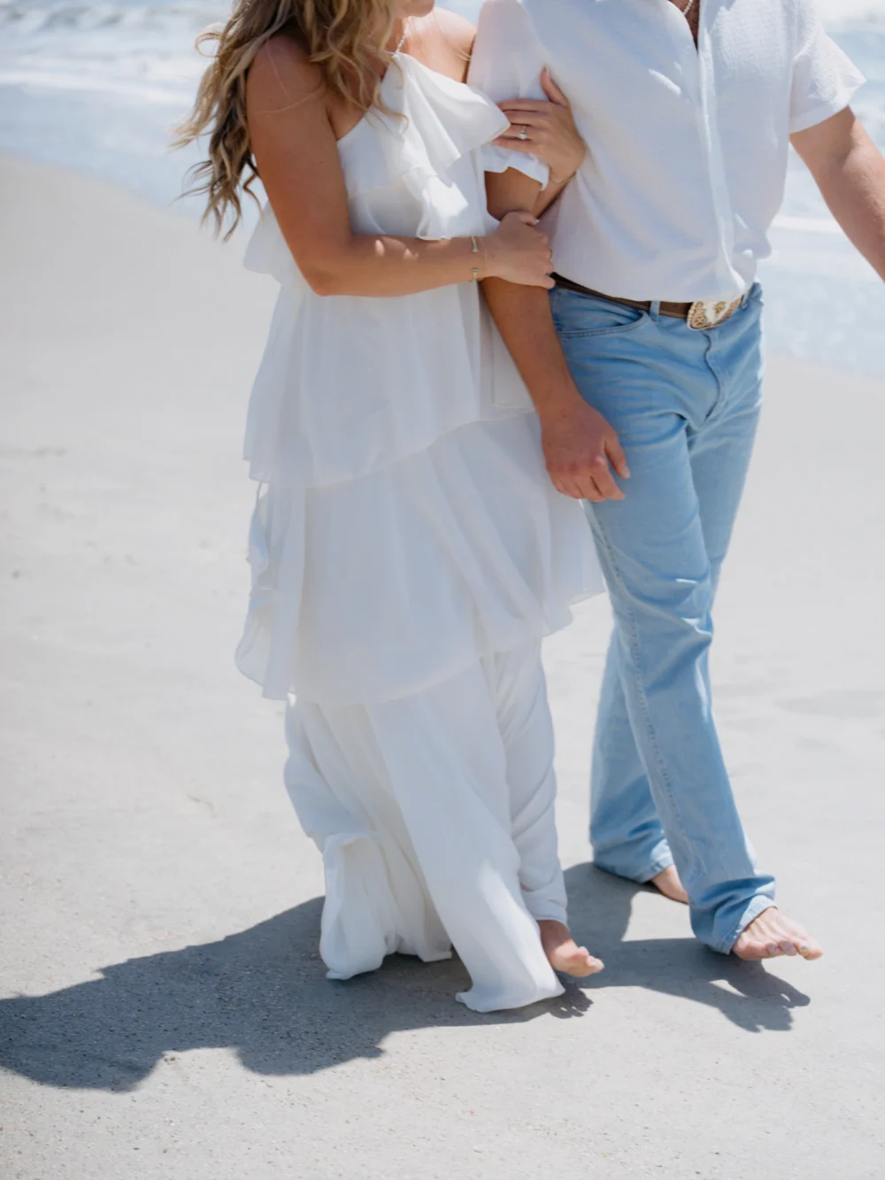 Couple walking along shoreline at Isle of Palms