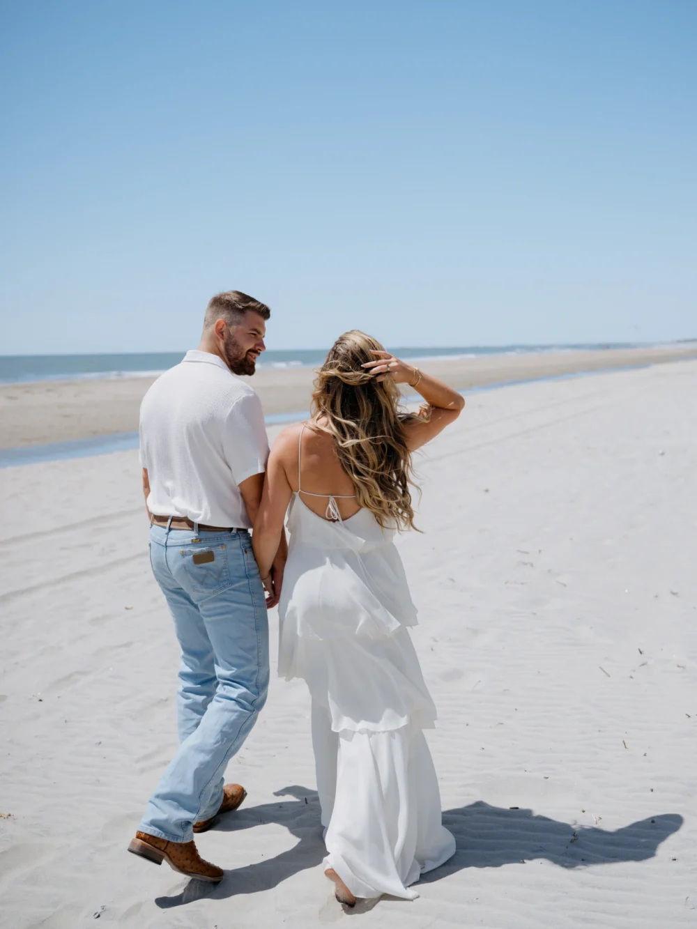 Couple walking along shoreline at Isle of Palms