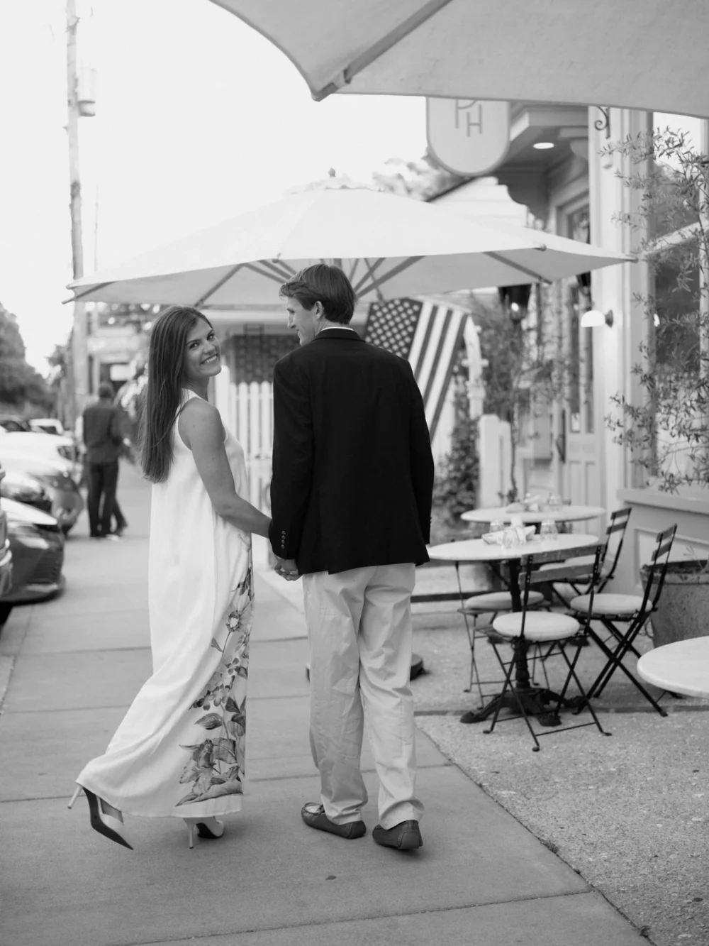Couple walking beside Post House during Pitt Street engagement session
