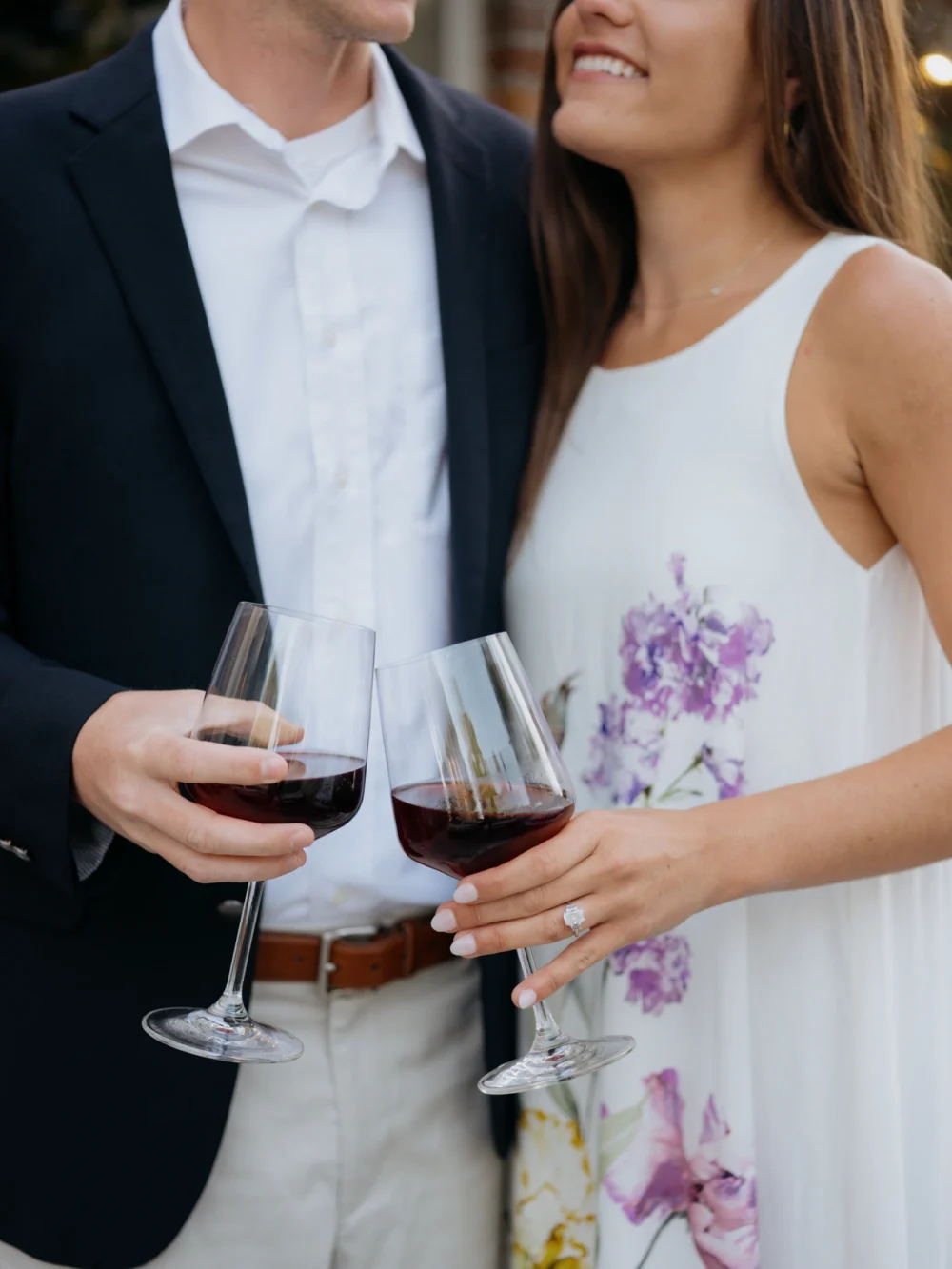 Engagement couple walking past the historic Wine Shop in Old Village Charleston
